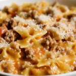 Bowl of creamy Velveeta beef and bowtie pasta, garnished with fresh parsley.