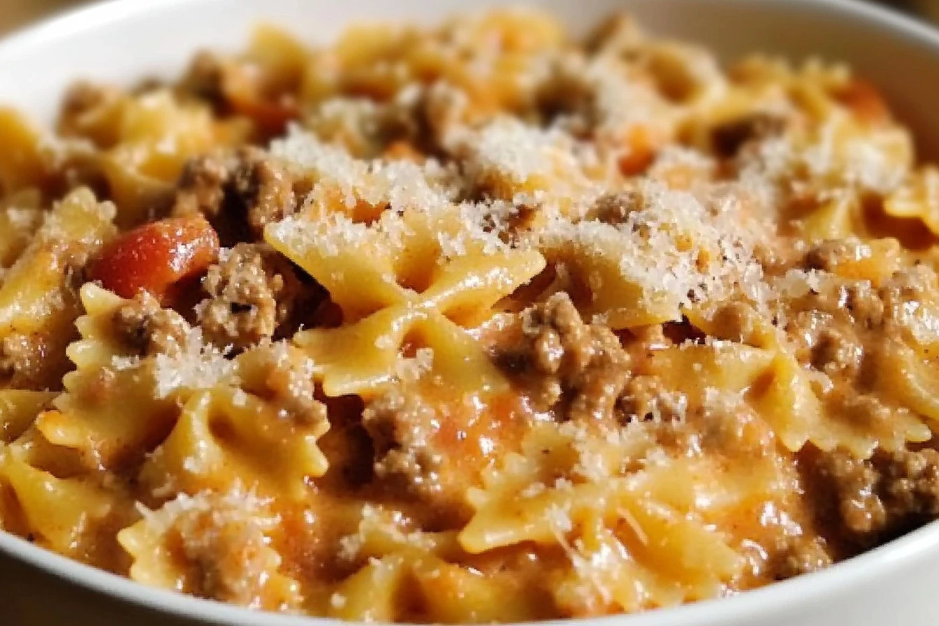 Bowl of creamy Velveeta beef and bowtie pasta, garnished with fresh parsley.